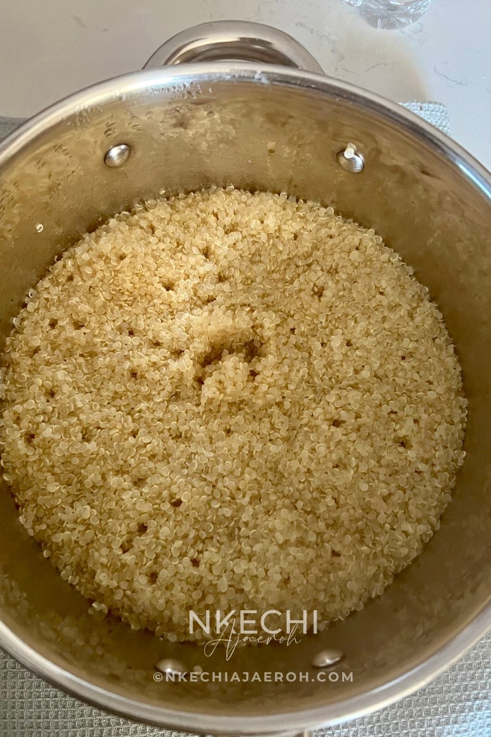 In a large pot, bring vegetable broth or water to a boil. Add the rinsed quinoa, along with a bay leaf and a sprig of fresh rosemary or thyme for flavor. Reduce the heat to low, cover the pot, and let it simmer for 15–18 minutes, or until all the liquid has been absorbed. Once done, remove from heat and let it rest (covered) for about 5 minutes. Then, fluff the quinoa with a fork to separate the grains and set it aside.