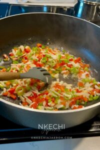 Heat olive oil in a large skillet over medium heat. Add the chopped onion and cook for 3–4 minutes, until soft and fragrant. Next, stir in 1 teaspoon of your favorite seasoning mix — this can be your house spice blend, Slap Ya Mama, Creole seasoning, or a vegetable Knorr bouillon cube. Add the minced garlic and chopped apples, and cook for another 1–2 minutes, until the apples start to soften.