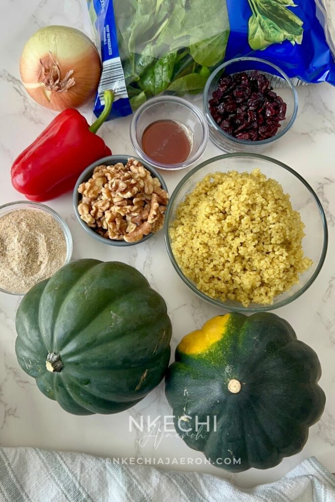 This Healthy Quinoa-Stuffed Acorn Squash is packed with wholesome quinoa, spinach, cranberries, and herbs. A delicious, gluten-free vegetarian main or side dish for your cozy fall meals or Thanksgiving table! Quinoa-stuffed acorn squash halves on a baking tray with fresh herbs. Roasted acorn squash filled with quinoa, cranberries, and spinach. Healthy vegetarian acorn squash stuffed with quinoa and nuts. Quinoa and vegetable filling being spooned into roasted acorn squash. Beautifully roasted acorn squash halves served for Thanksgiving dinner.