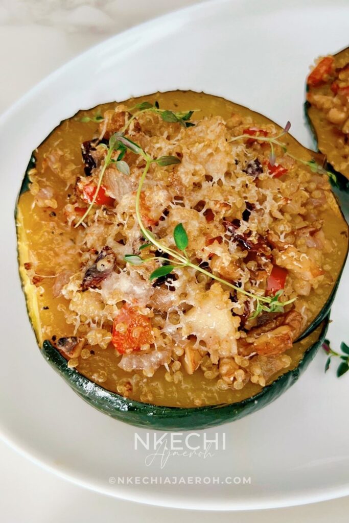 This Healthy Quinoa-Stuffed Acorn Squash is packed with wholesome quinoa, spinach, cranberries, and herbs. A delicious, gluten-free vegetarian main or side dish for your cozy fall meals or Thanksgiving table! Quinoa-stuffed acorn squash halves on a baking tray with fresh herbs. Roasted acorn squash filled with quinoa, cranberries, and spinach. Healthy vegetarian acorn squash stuffed with quinoa and nuts. Quinoa and vegetable filling being spooned into roasted acorn squash. Beautifully roasted acorn squash halves served for Thanksgiving dinner.