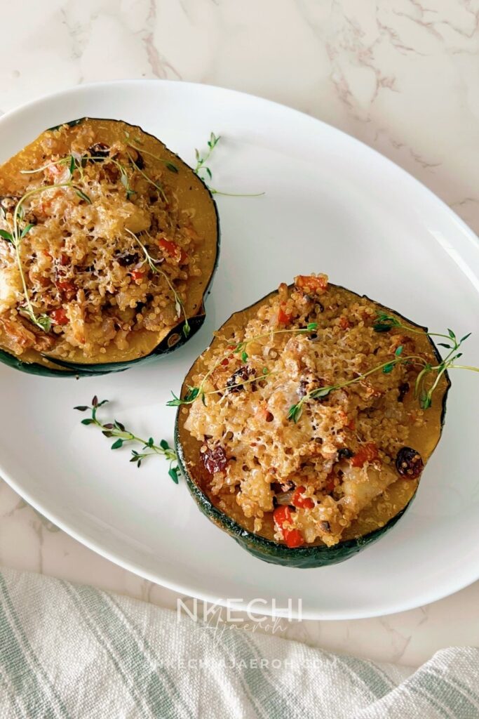 This Healthy Quinoa-Stuffed Acorn Squash is packed with wholesome quinoa, spinach, cranberries, and herbs. A delicious, gluten-free vegetarian main or side dish for your cozy fall meals or Thanksgiving table! Quinoa-stuffed acorn squash halves on a baking tray with fresh herbs. Roasted acorn squash filled with quinoa, cranberries, and spinach. Healthy vegetarian acorn squash stuffed with quinoa and nuts. Quinoa and vegetable filling being spooned into roasted acorn squash. Beautifully roasted acorn squash halves served for Thanksgiving dinner.