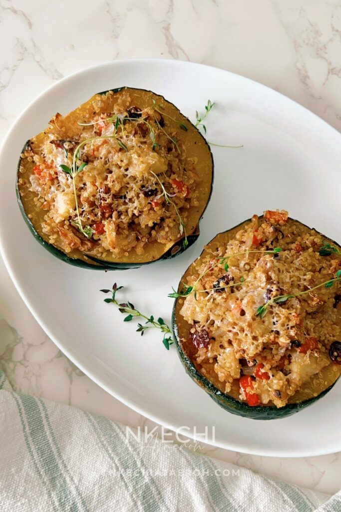 This Healthy Quinoa-Stuffed Acorn Squash is packed with wholesome quinoa, spinach, cranberries, and herbs. A delicious, gluten-free vegetarian main or side dish for your cozy fall meals or Thanksgiving table! Quinoa-stuffed acorn squash halves on a baking tray with fresh herbs. Roasted acorn squash filled with quinoa, cranberries, and spinach. Healthy vegetarian acorn squash stuffed with quinoa and nuts. Quinoa and vegetable filling being spooned into roasted acorn squash. Beautifully roasted acorn squash halves served for Thanksgiving dinner.