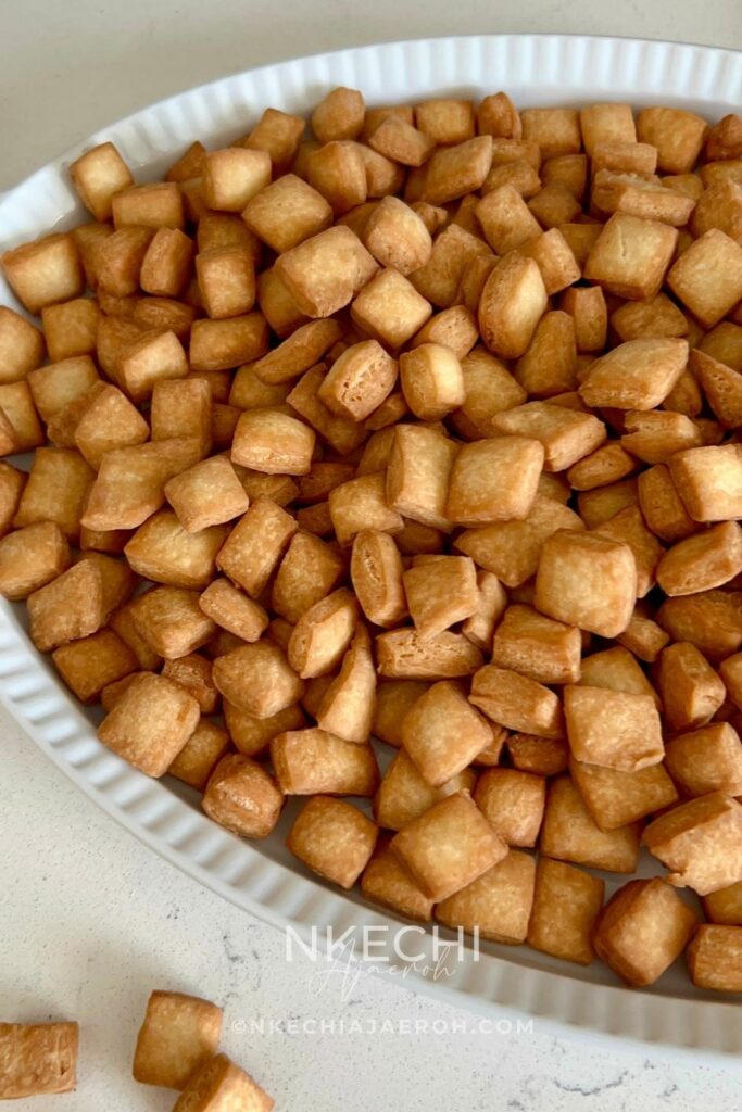 Nigerian chin chin is a popular West African snack known for its crunchy texture, buttery flavor, and lightly sweet taste. Made from a simple dough of flour, butter, sugar, eggs, and nutmeg, chin chin is rolled, cut into small pieces, and fried until golden and crisp. This classic snack is a staple at holidays, birthdays, weddings, and family gatherings, and it’s just as common to find it sold as street food. Chin chin stays crunchy for days and is easy to make in large batches, which makes it perfect for sharing and gifting.