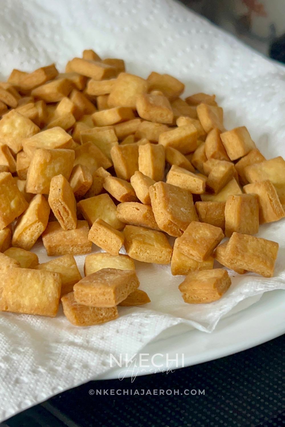 Nigerian chin chin is a popular West African snack known for its crunchy texture, buttery flavor, and lightly sweet taste. Made from a simple dough of flour, butter, sugar, eggs, and nutmeg, chin chin is rolled, cut into small pieces, and fried until golden and crisp. This classic snack is a staple at holidays, birthdays, weddings, and family gatherings, and it’s just as common to find it sold as street food. Chin chin stays crunchy for days and is easy to make in large batches, which makes it perfect for sharing and gifting.