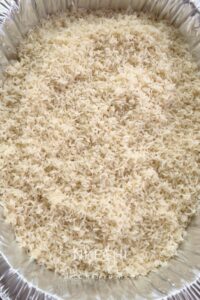 Transfer the drained rice into a large, deep baking dish or disposable aluminum foil pan. I always defer to aluminum foil because it's lightweight and I do not have to wash it afterwards.