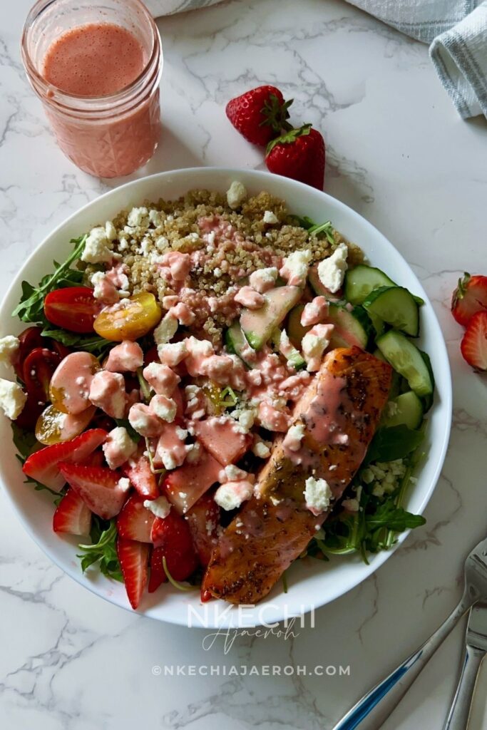 Fresh salmon, fluffy quinoa, peppery arugula, juicy strawberries, crunchy cucumbers, cherry tomatoes, creamy feta, and a homemade strawberry vinaigrette come together to create one of the most satisfying salads you'll ever make.
