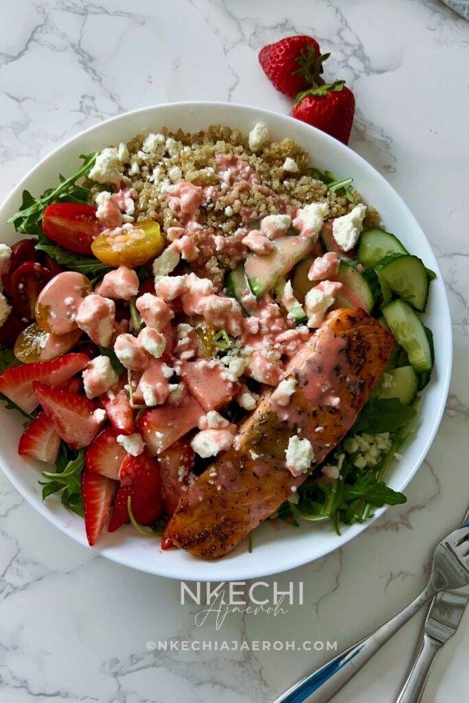 Looking for the perfect healthy summer salad? This Salmon Strawberry Quinoa Arugula Salad is inspired by one of my favorite restaurant bowls and combines perfectly seasoned salmon, fluffy quinoa, peppery arugula, juicy strawberries, cucumbers, tomatoes, feta, and a homemade fresh strawberry dressing. It's high in protein, meal-prep friendly, and ready in about 20 minutes. Perfect for lunch, dinner, or whenever you need a fresh, satisfying meal.