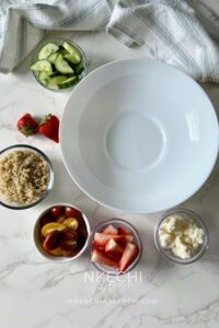 While the salmon cooks, wash and dry the arugula. Slice the strawberries, dice the cucumber, and halve the cherry tomatoes. If your quinoa isn't already cooked, prepare it according to the package instructions and allow it to cool slightly.