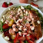 Looking for a healthy, high-protein summer salad? This Salmon Strawberry Quinoa Salad is a fresh, high-protein meal inspired by one of my favorite CAVA bowls. Made with perfectly seasoned salmon, fluffy quinoa, peppery arugula, juicy strawberries, crisp vegetables, creamy feta, and a homemade strawberry dressing, it's an easy, restaurant-worthy salad you'll want to make all summer long.