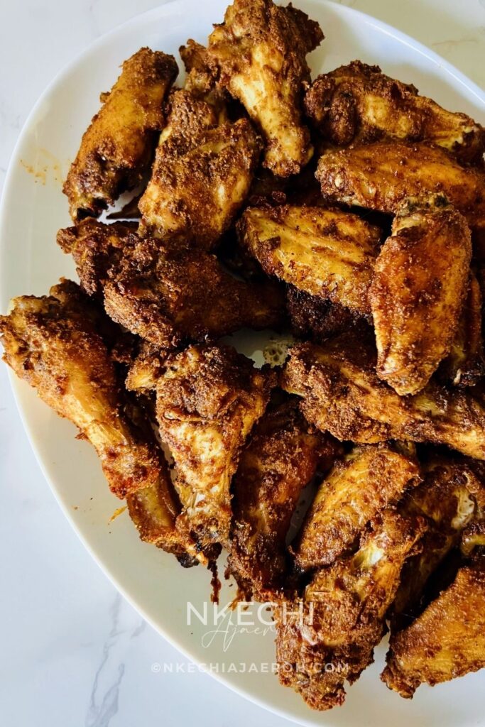 These Air Fryer Nigerian Chicken Suya Wings are juicy, crispy, spicy, and loaded with authentic 9ja flavor! Chicken wings are generously seasoned with yaji/suya pepper and air-fried until perfectly cooked and crisp. Serve these easy Nigerian suya wings with fresh onions and tomatoes, enjoy them as an appetizer, or pair them with jollof rice for dinner. A must-try Nigerian chicken recipe for suya lovers!