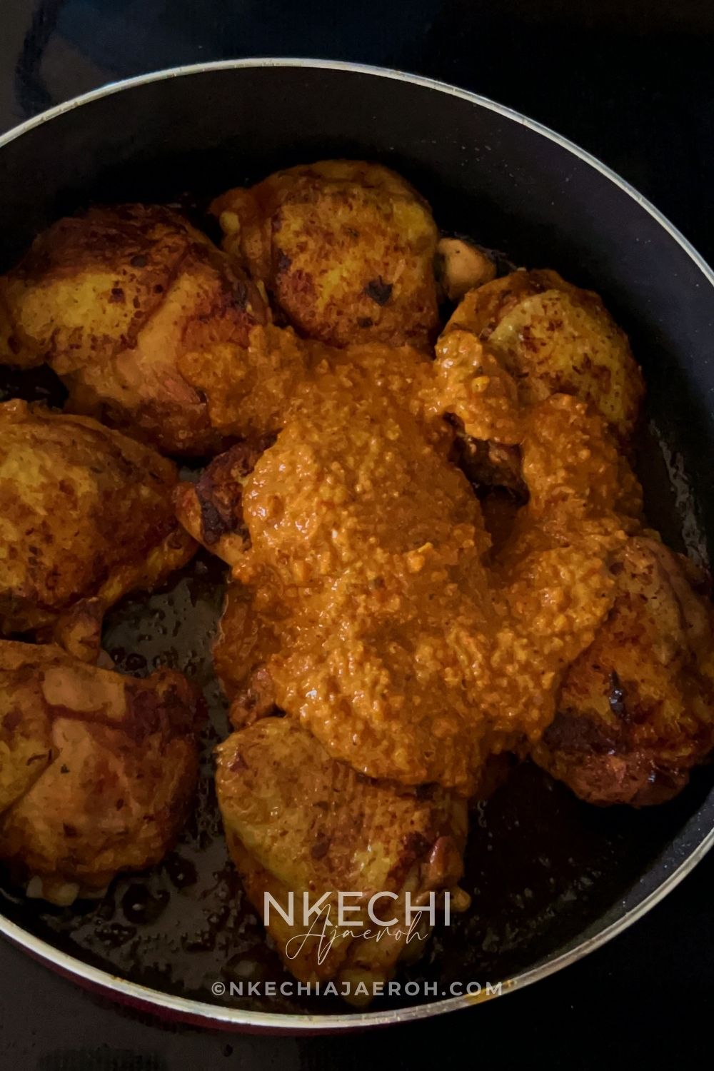 Pour the homemade peri peri sauce over the browned chicken and gently stir to coat each piece. Reduce the heat to low and cover the pan.