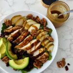 Looking for an easy healthy chicken salad? This Chicken Pear Salad is loaded with juicy chicken, fresh pear, avocado, dried cranberries, toasted walnuts, and mixed greens, then finished with a simple balsamic maple dressing. It's an easy high-protein salad for lunch or dinner and a delicious way to use leftover chicken. Perfect for fall, but delicious any time you can find good pears!