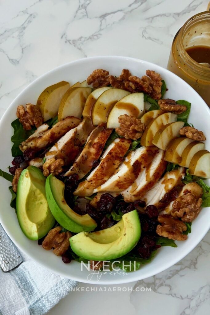 Looking for an easy healthy chicken salad? This Chicken Pear Salad is loaded with juicy chicken, fresh pear, avocado, dried cranberries, toasted walnuts, and mixed greens, then finished with a simple balsamic maple dressing. It's an easy high-protein salad for lunch or dinner and a delicious way to use leftover chicken. Perfect for fall, but delicious any time you can find good pears!
