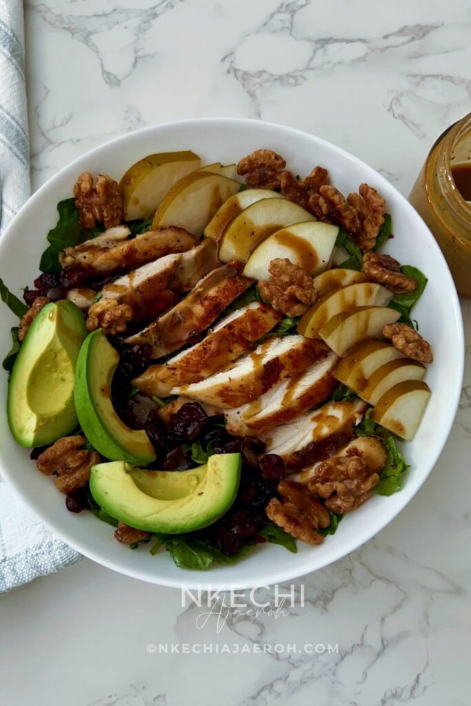 Looking for an easy healthy chicken salad? This Chicken Pear Salad is loaded with juicy chicken, fresh pear, avocado, dried cranberries, toasted walnuts, and mixed greens, then finished with a simple balsamic maple dressing. It's an easy high-protein salad for lunch or dinner and a delicious way to use leftover chicken. Perfect for fall, but delicious any time you can find good pears!