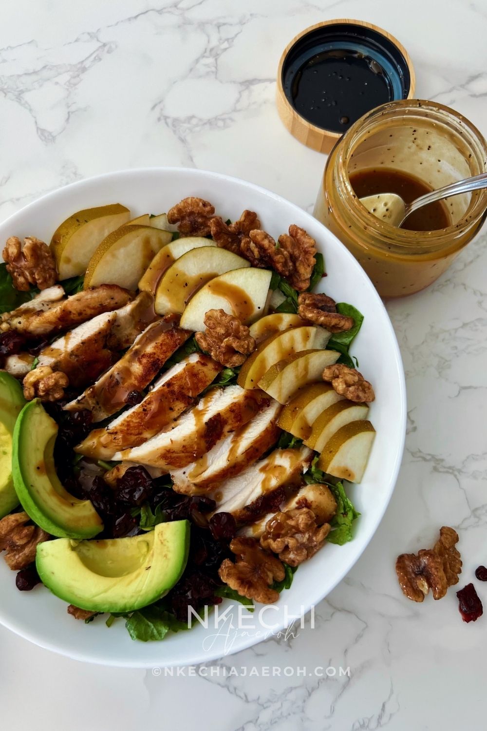 Looking for an easy healthy chicken salad? This Chicken Pear Salad is loaded with juicy chicken, fresh pear, avocado, dried cranberries, toasted walnuts, and mixed greens, then finished with a simple balsamic maple dressing. It's an easy high-protein salad for lunch or dinner and a delicious way to use leftover chicken. Perfect for fall, but delicious any time you can find good pears!