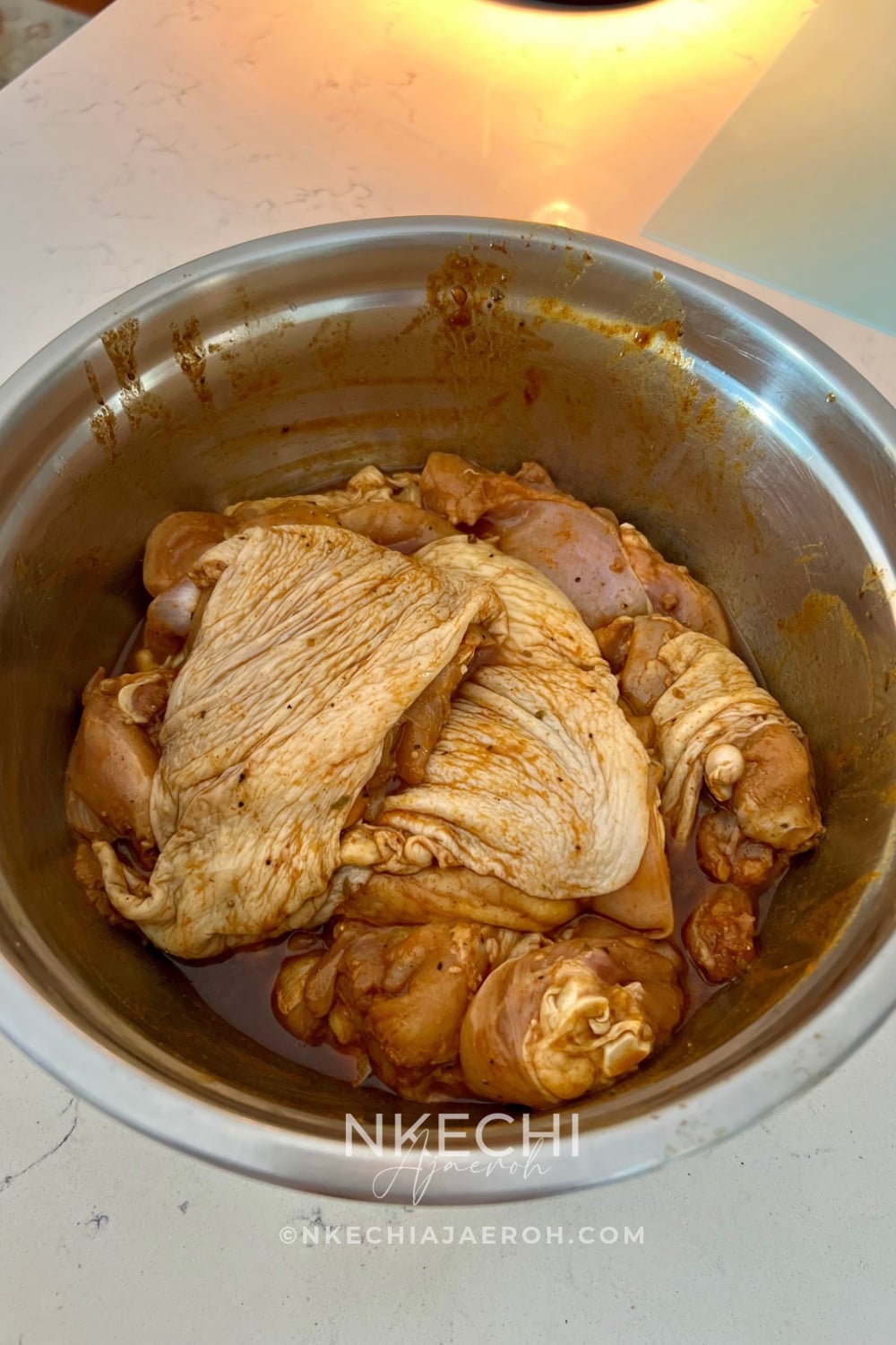 Clean/wash your chicken (if you do wash your chicken - I do wash mine). Pat the chicken thighs thoroughly dry with paper towels. Place them in a large bowl and sprinkle with the additional teaspoon of Knorr chicken bouillon and rub in.
Add approximately ½ cup of the prepared marinade, or enough to coat the chicken thoroughly. Wearing food-safe gloves if desired, massage it over the thighs and gently underneath the skin.