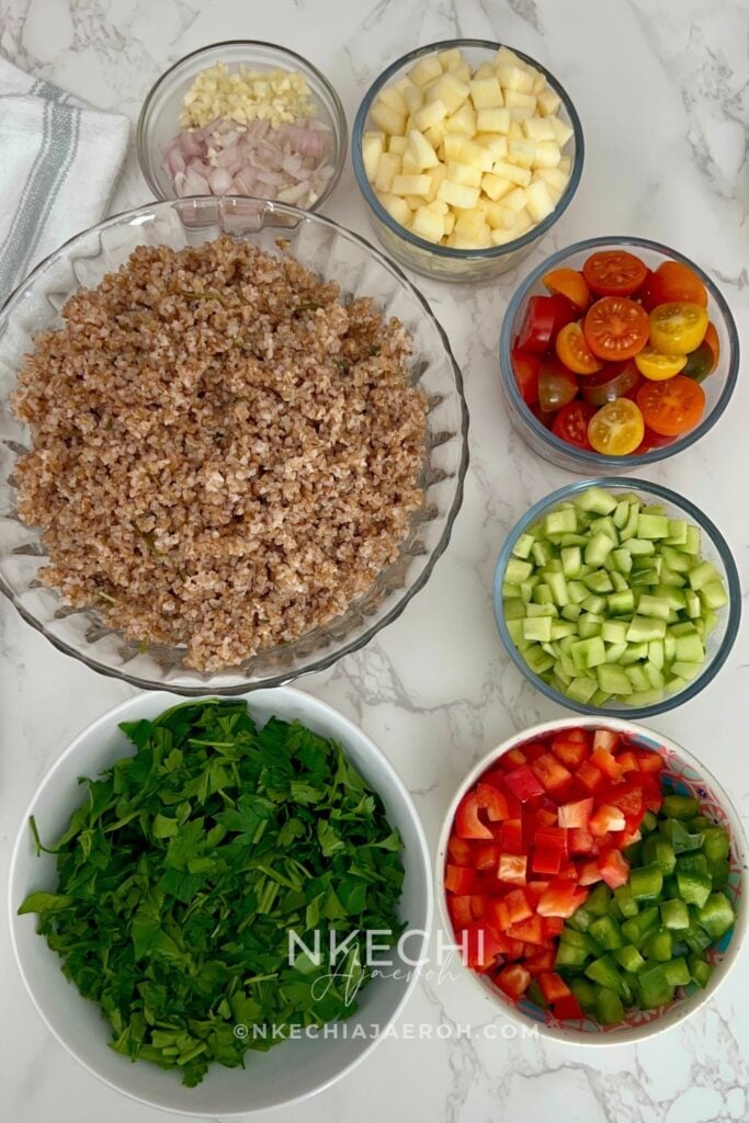 Wash the bell peppers, cucumbers, apple, and grape tomatoes. Dice the bell peppers and cucumbers, mince the shallot and garlic, and halve the grape tomatoes. Peel and finely dice the apple. Thoroughly wash and chop the fresh Italian flat-leaf parsley.