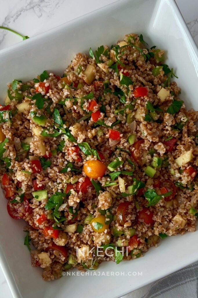 Looking for an easy, colorful Mediterranean Bulgur Salad? This delicious bulgur wheat salad combines nutty red bulgur, crisp vegetables, sweet apples, fresh parsley, and a zesty lemon date dressing with a touch of date syrup. Naturally dairy-free and made without feta, it's perfect for healthy meal prep, weekday lunches, family dinners, or serving alongside chicken, salmon, or lamb. A fresh, nourishing Mediterranean grain salad that's easy to customize with your favorite vegetables. Save this recipe for later! 